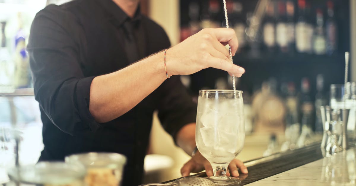 What is the tipping process in restaurants in the US? - Crop barman making cocktail in pub What is the tipping process in restaurants in the US? - Crop barman making cocktail in pub