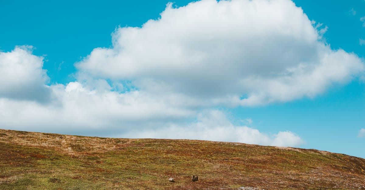 What is the transit procedure in AMS when en route from a Schengen country to the USA? - Landscape of hill slope with clouds above What is the transit procedure in AMS when en route from a Schengen country to the USA? - Landscape of hill slope with clouds above