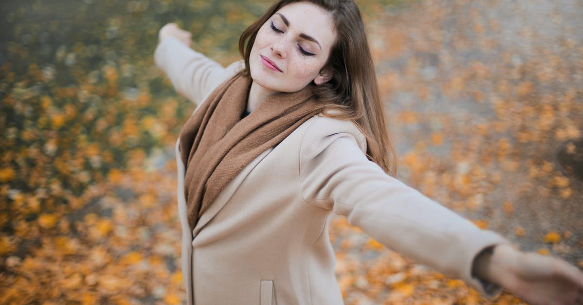 What is the typical ratio of paid versus free miles in frequent flyer programs? [closed] - Woman in Beige Long Sleeve Coat Standing on Brown Leaves