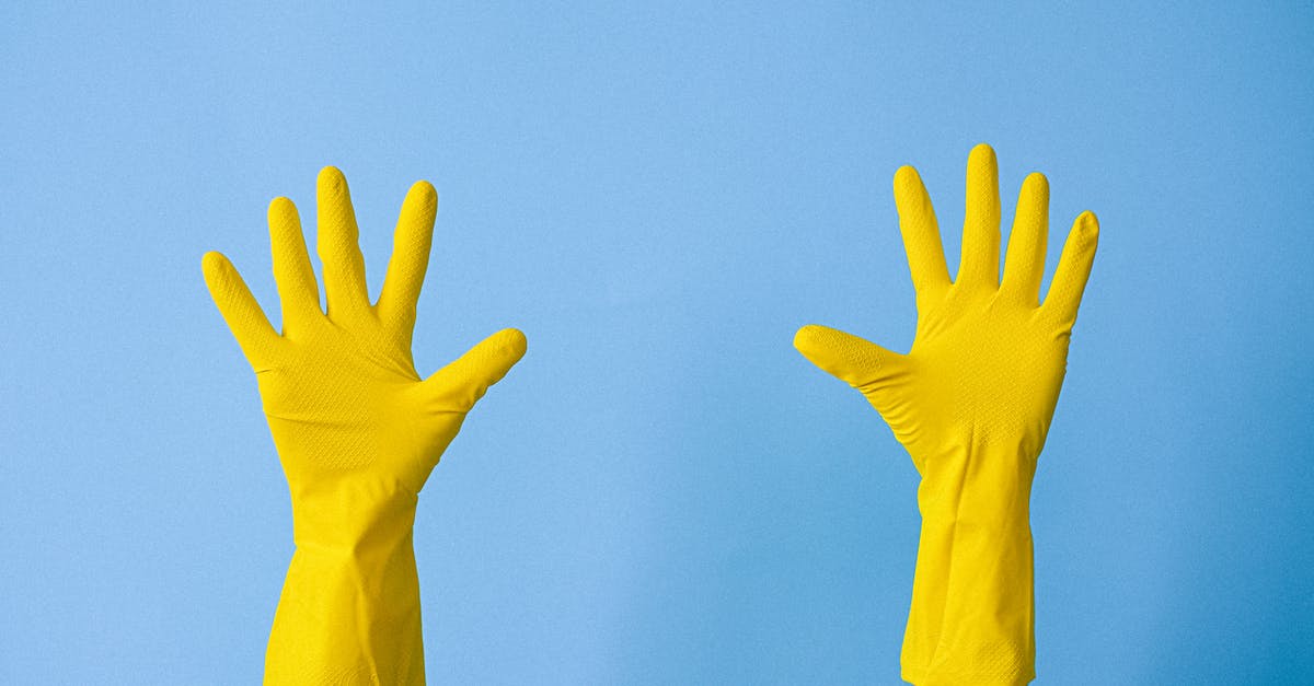 What is this indication - Crop unrecognizable person in rubber gloves raising arms What is this indication - Crop unrecognizable person in rubber gloves raising arms