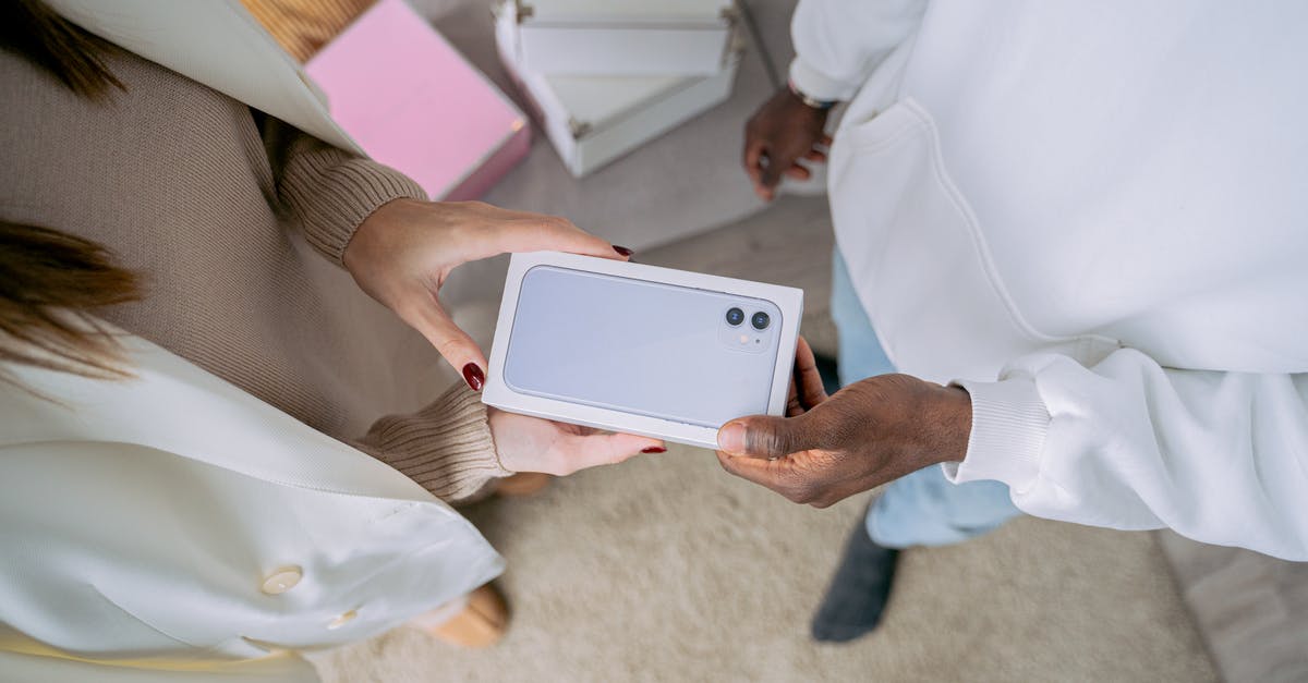 What is this present we received from our hotel in China? [closed] - Woman Receiving Box with New Smartphone