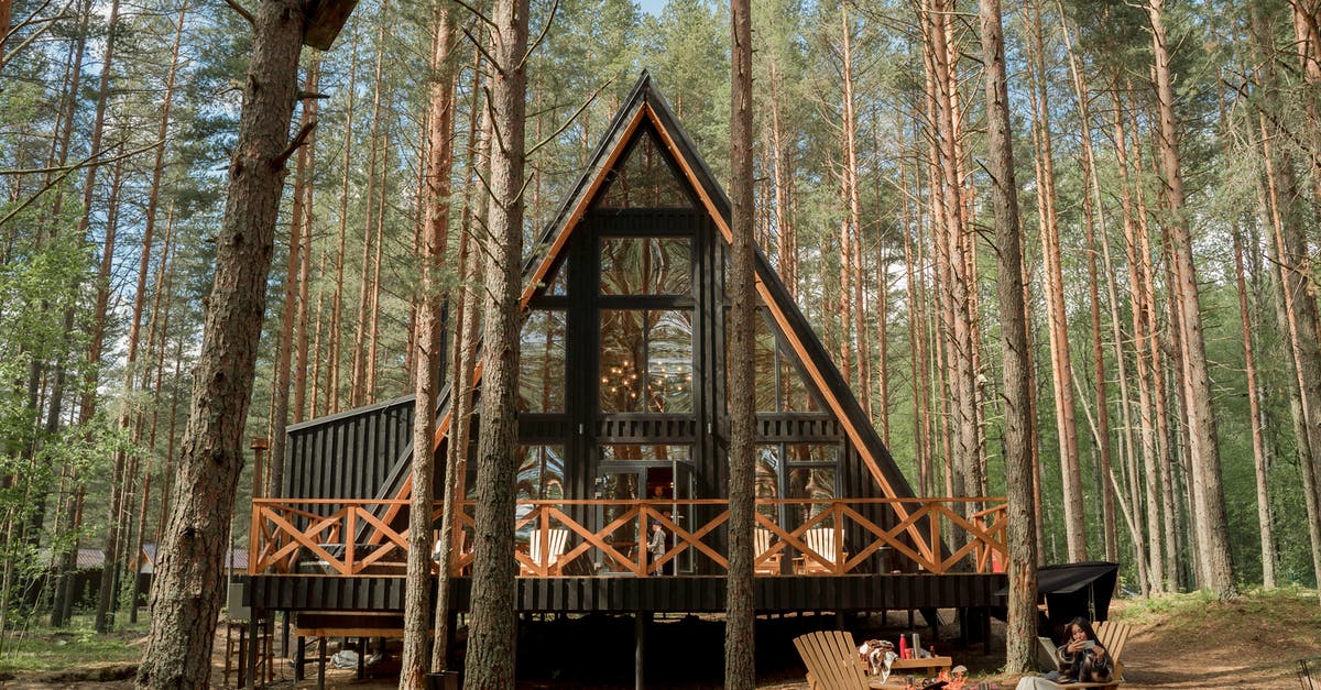 What is this shape on the airplane chairs for? - A Wooden House with Glass Wall on Camping Site What is this shape on the airplane chairs for? - A Wooden House with Glass Wall on Camping Site