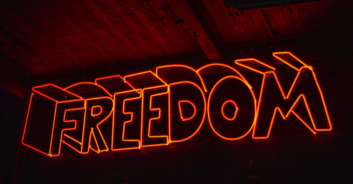 What is this sign with red triangle and black bottom up "T" on cars in Lithuania? - Close-up Photo Of Red Neon Light Signage What is this sign with red triangle and black bottom up "T" on cars in Lithuania? - Close-up Photo Of Red Neon Light Signage