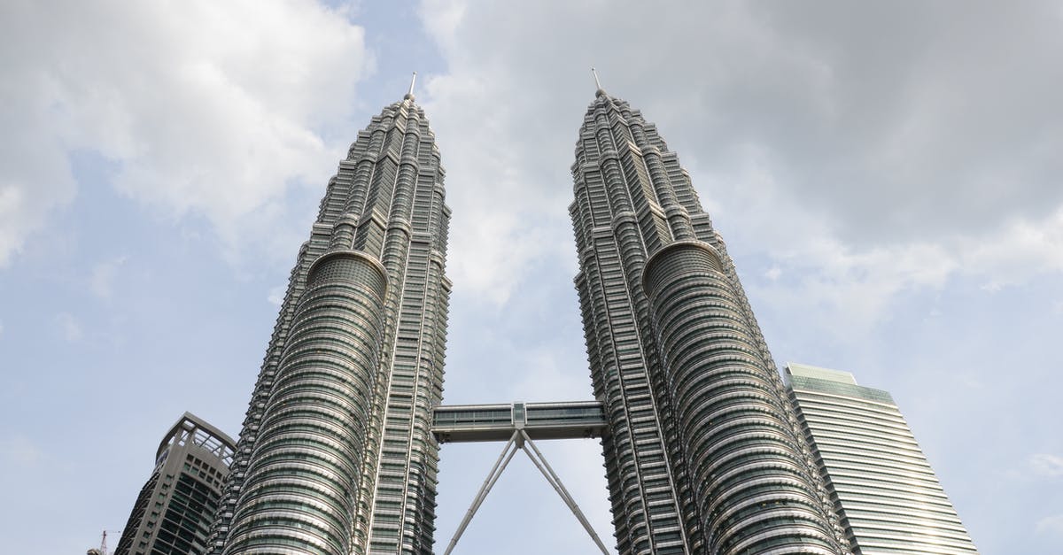 What kind of a visa do I require to halt at Kuala Lumpur for 3 days while travelling from Mumbai to Melbourne via Kuala Lumpur? - From below tall futuristic twin towers with steel and glass facade located against cloudy sky in Kuala Lumpur