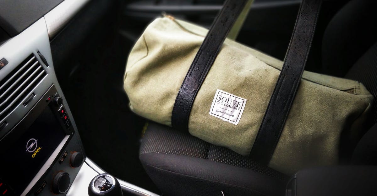 What kind of bag can I use to travel with a baby car seat? - Brown and Black Duffel Bag on a Car Seat What kind of bag can I use to travel with a baby car seat? - Brown and Black Duffel Bag on a Car Seat