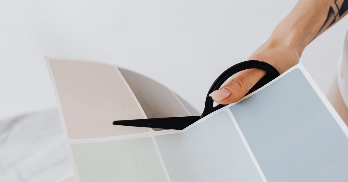 What kind of nail scissors have a good chance of being allowed in hand (carry-on) luggage in the EU? - Woman Cutting Colour Samples with Scissors