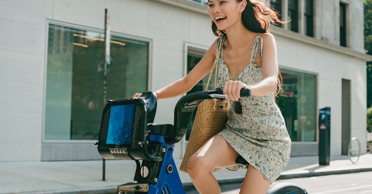 What kind of roads am I not allowed to ride my bicycle on in Switzerland? - Happy young Asian lady smiling and riding bike on street What kind of roads am I not allowed to ride my bicycle on in Switzerland? - Happy young Asian lady smiling and riding bike on street