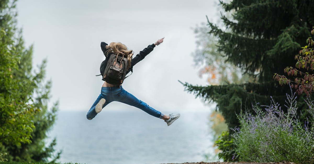 What makes a backpack a women's backpack? - Woman Jumping Wearing Green Backpack What makes a backpack a women's backpack? - Woman Jumping Wearing Green Backpack
