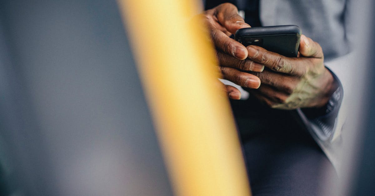 What mobile taxi app can I use in Kutaisi Georgia? - Crop anonymous male in formal clothes sitting in car and browsing modern mobile phone What mobile taxi app can I use in Kutaisi Georgia? - Crop anonymous male in formal clothes sitting in car and browsing modern mobile phone