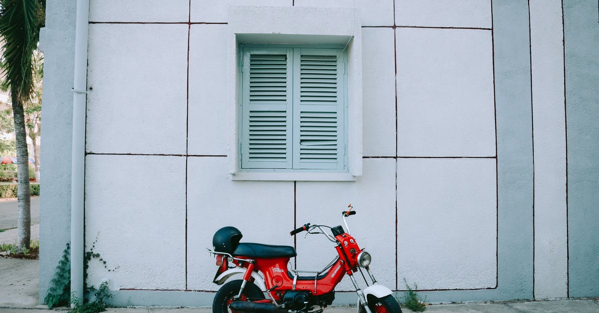 What motorbike to use in Vietnam - Red Motor Scooter Parked Beside White Concrete Building What motorbike to use in Vietnam - Red Motor Scooter Parked Beside White Concrete Building