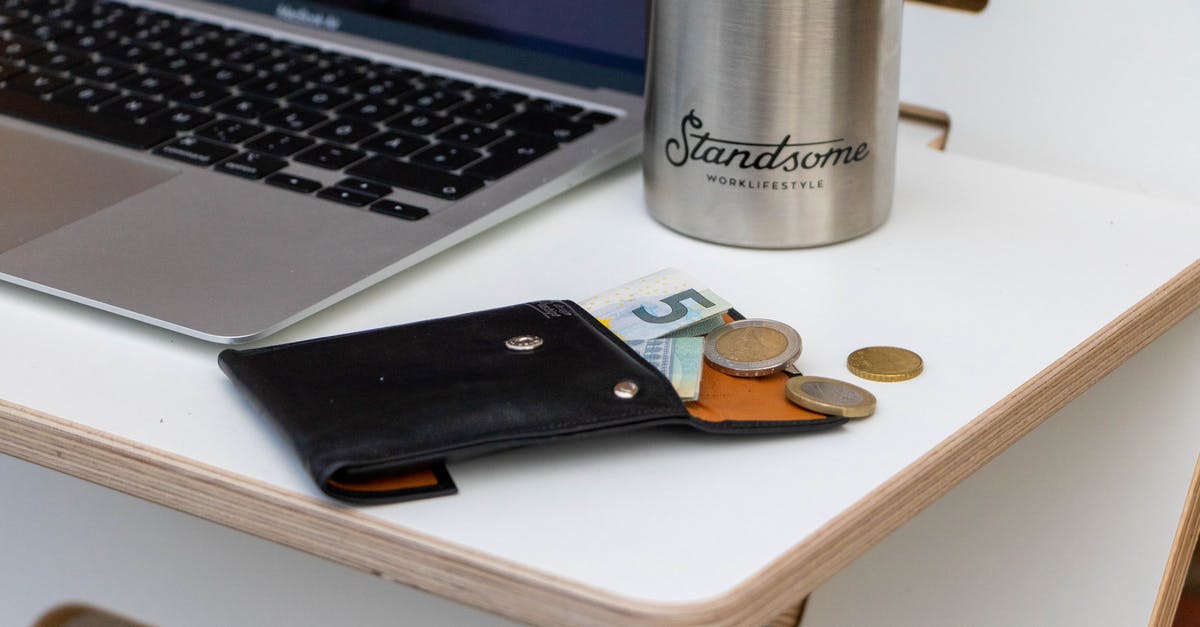 What needs to be paid in cash on an all-inclusive Egypt vacation? [closed] - Silver Macbook Pro Beside Brown Wooden Chopping Board and Silver Round Coins