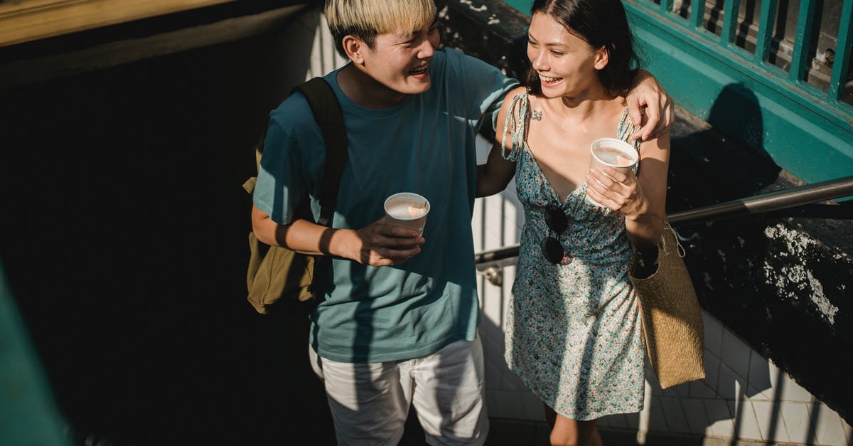 What other cities (outside Poland) are easily accessed by train from Kraków? - From above of cheerful Asian couple with coffee looking at each other and hugging while getting out of subway station What other cities (outside Poland) are easily accessed by train from Kraków? - From above of cheerful Asian couple with coffee looking at each other and hugging while getting out of subway station