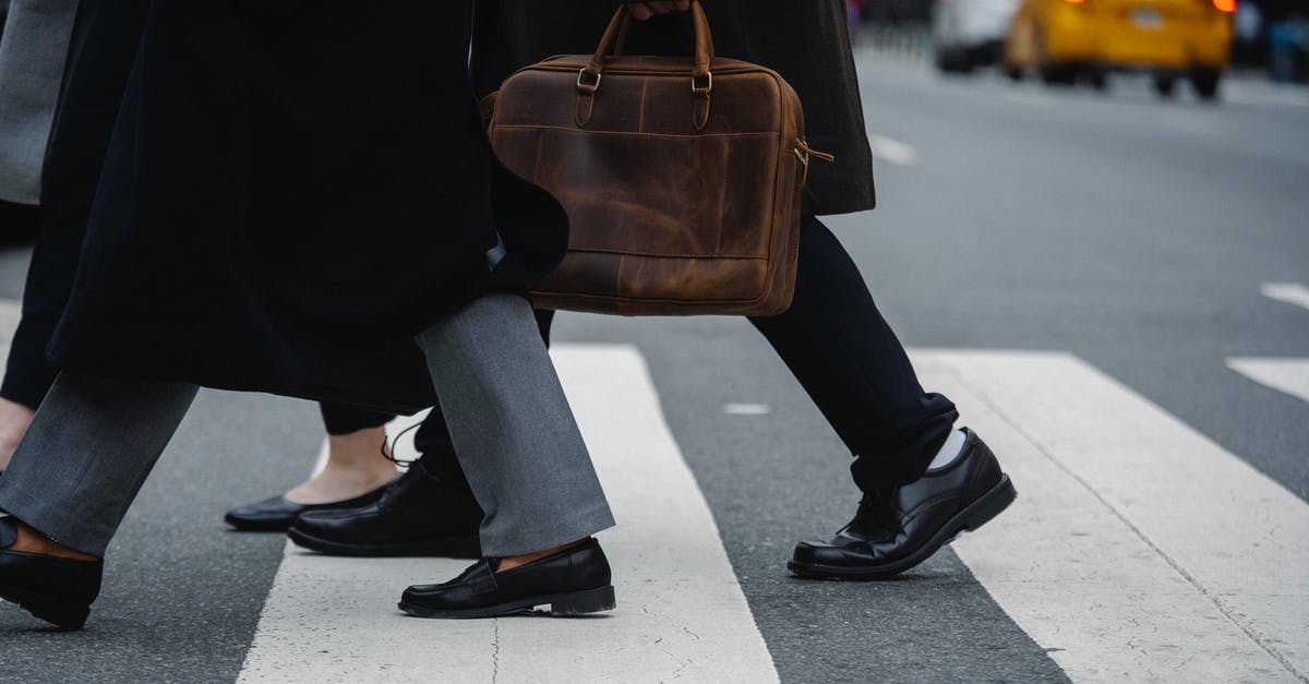 What paperwork is needed to cross non-EU Balkan borders with a rental car? - Side view of crop unrecognizable coworkers in formal wear with leather briefcase crossing urban road What paperwork is needed to cross non-EU Balkan borders with a rental car? - Side view of crop unrecognizable coworkers in formal wear with leather briefcase crossing urban road