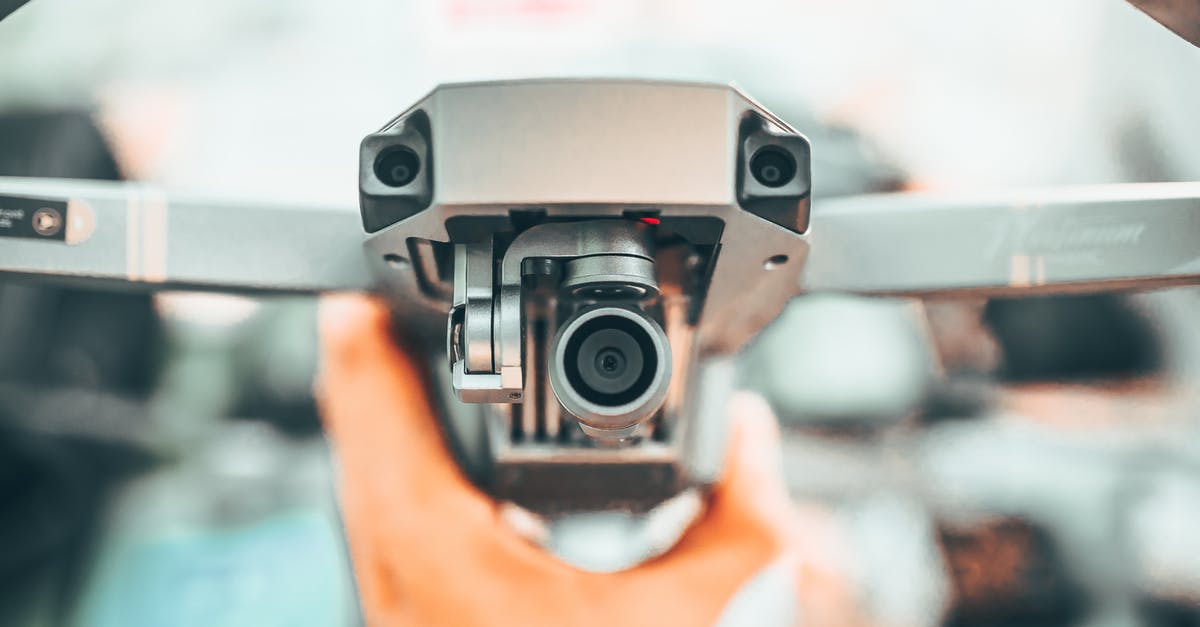 What powerbank can I use on the flight? - Crop unrecognizable person holding contemporary drone against blurred interior and demonstrating powerful camera What powerbank can I use on the flight? - Crop unrecognizable person holding contemporary drone against blurred interior and demonstrating powerful camera
