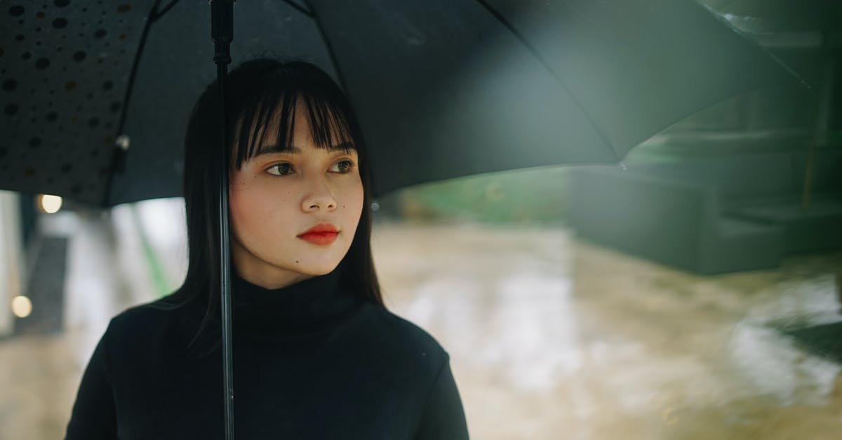 What should I wear in the tropics during the rainy season? - Photo of Woman Holding Black Umbrella What should I wear in the tropics during the rainy season? - Photo of Woman Holding Black Umbrella