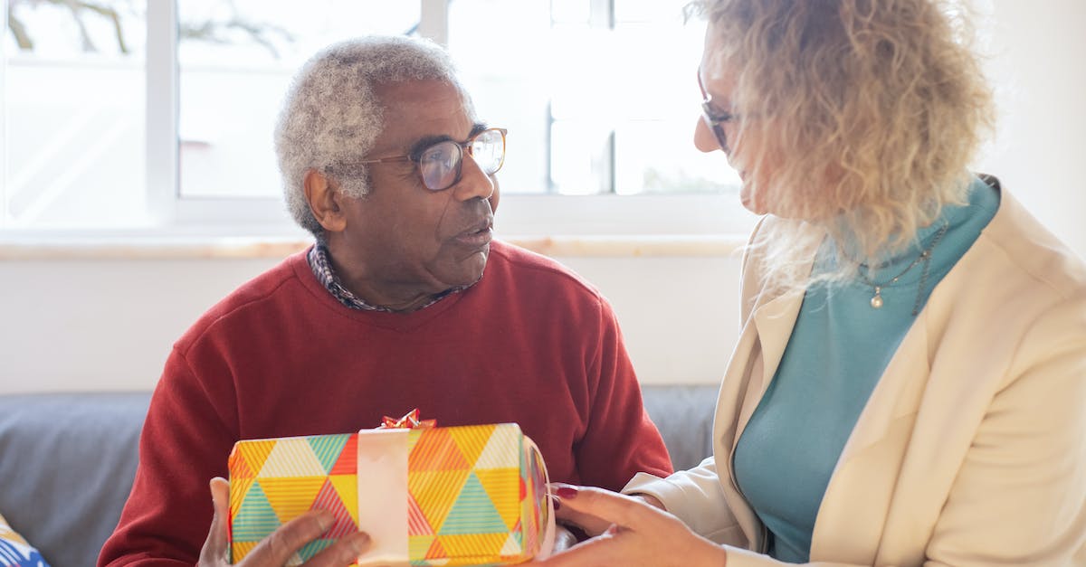 What should we consider when buying a gift for a host family in Turkey? - Man in Red Crew Neck Shirt Holding Yellow and White Box What should we consider when buying a gift for a host family in Turkey? - Man in Red Crew Neck Shirt Holding Yellow and White Box