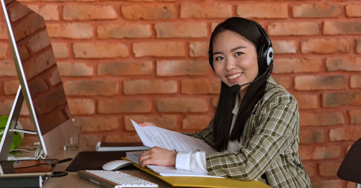 What supporting documents should I include in my UK visa application? - Smiling Woman with Headset Holding Files at Work What supporting documents should I include in my UK visa application? - Smiling Woman with Headset Holding Files at Work