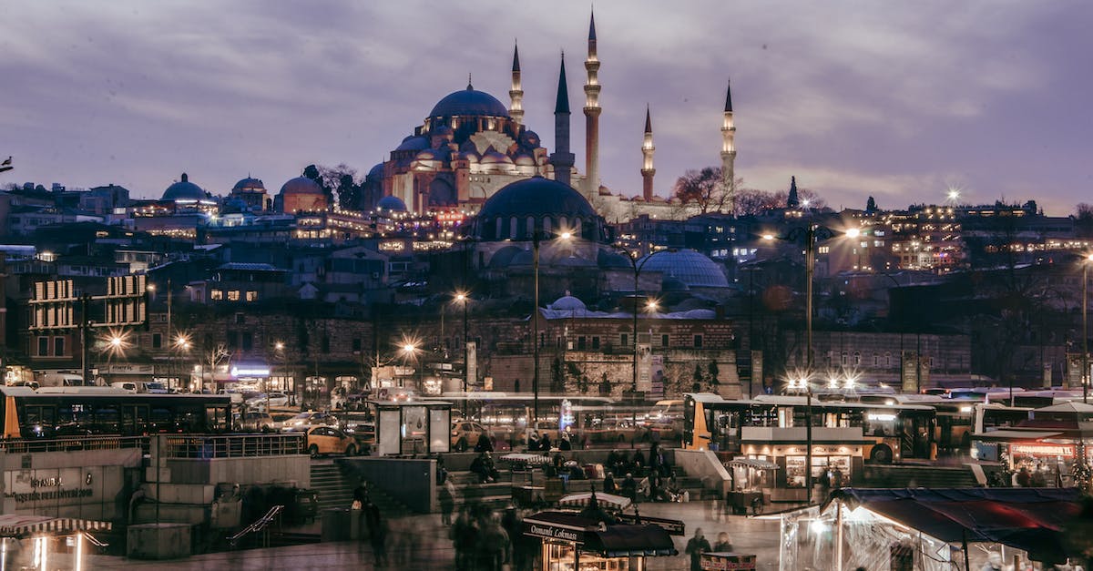 What time do the city buses start running in Istanbul? - Concrete Buildings Near the Busy Street During Night Time What time do the city buses start running in Istanbul? - Concrete Buildings Near the Busy Street During Night Time