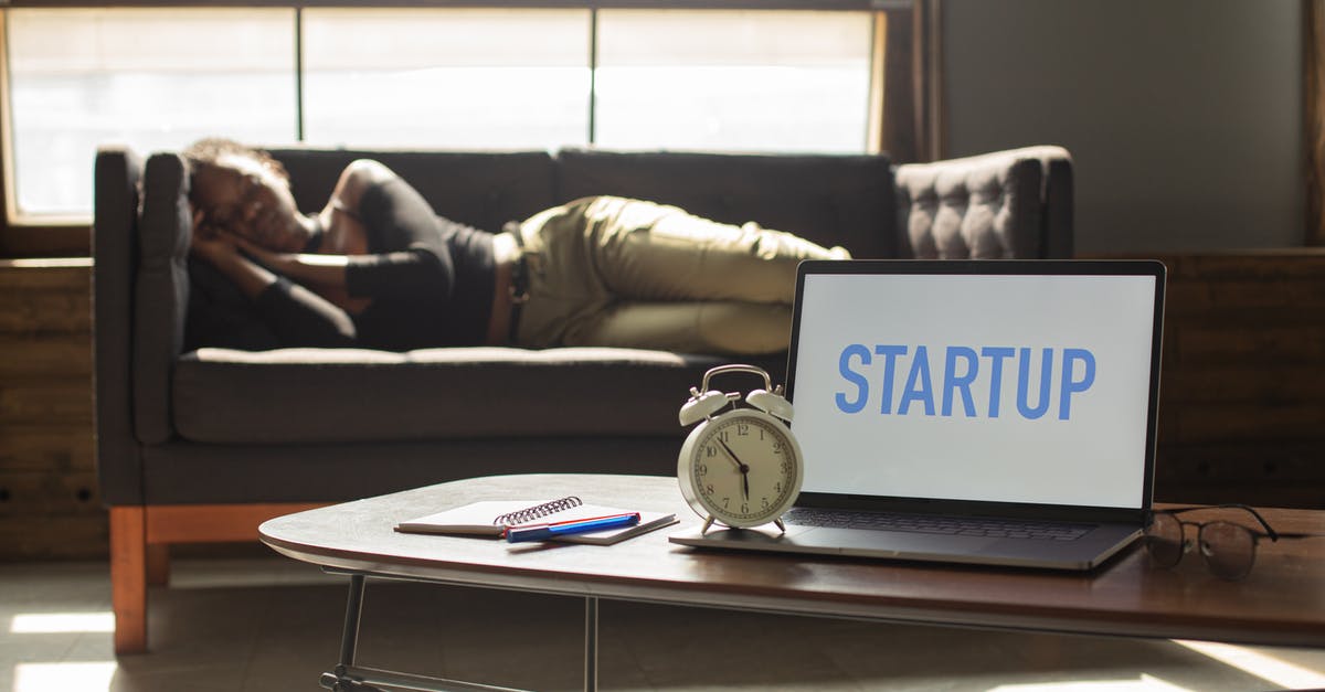 What time does siesta start and finish in Spain? - Unrecognizable black woman sleeping on couch near laptop What time does siesta start and finish in Spain? - Unrecognizable black woman sleeping on couch near laptop