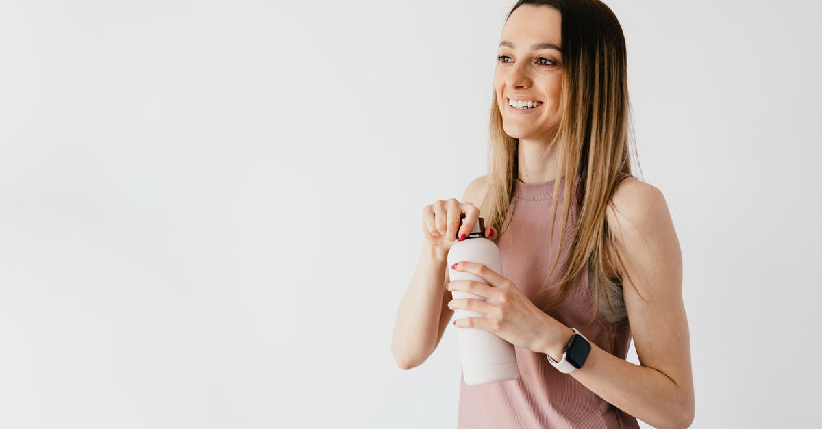 What time does the Seoul subway system open in the morning? - Happy young woman opening cosmetic bottle while standing against white background What time does the Seoul subway system open in the morning? - Happy young woman opening cosmetic bottle while standing against white background