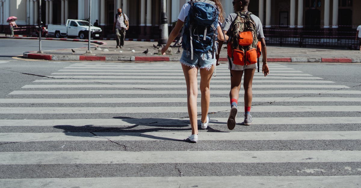 What to do before traveling to Europe as an American? [closed] - Two Friends Crossing the Pedestrian Lane