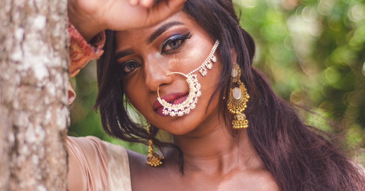 What to do if alone in B&B and the doorbell rings? [closed] - Selective Focus Close-up Portrait Photo of Indian Woman With Nose Ring Posing By Tree
