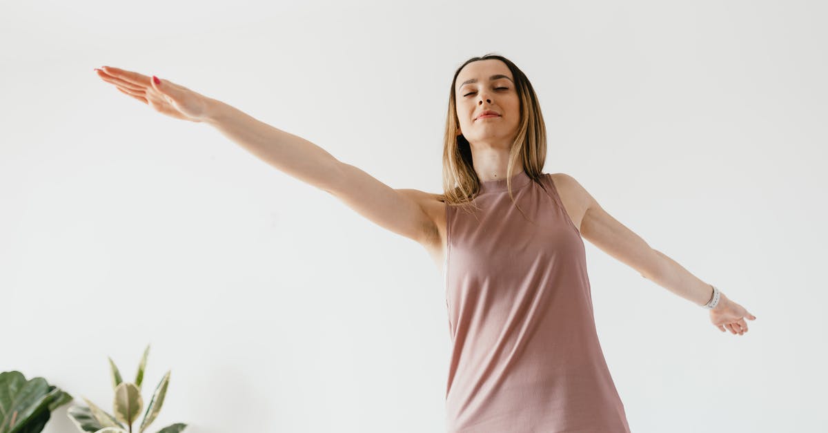 What to do if alone in B&B and the doorbell rings? [closed] - From below of calm young female performing Warrior II yoga asana with extended arms and closed eyes