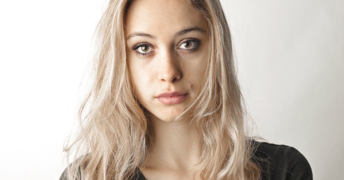 What to do with long facial hair in the onsen? - Woman in Gray Shirt Standing Beside White Wall What to do with long facial hair in the onsen? - Woman in Gray Shirt Standing Beside White Wall