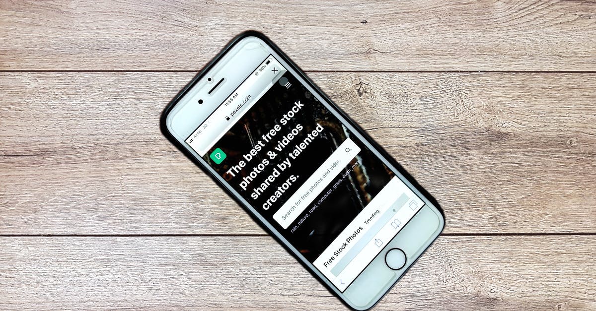 What to expect at a Global Entry application interview? - Top view contemporary mobile phone with opened website on screen placed on wooden table