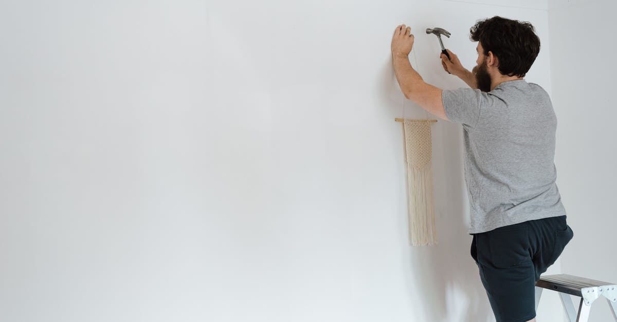 What to put for Current Employer in DS-160 Form when I haven't started yet? - Anonymous hipster man putting decor on wall in new house What to put for Current Employer in DS-160 Form when I haven't started yet? - Anonymous hipster man putting decor on wall in new house