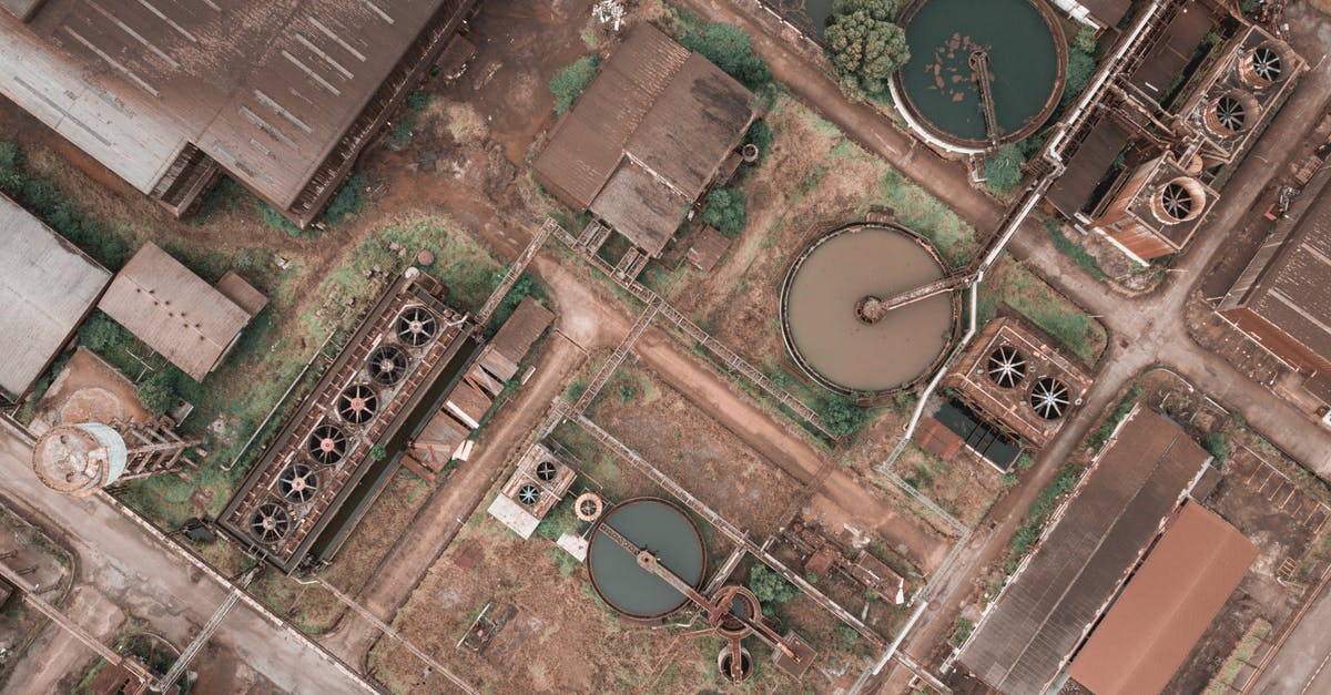 What type of power outlets are used in Bath, UK? - Drone view of shabby factory with round settling tanks with mechanical means removing solids in water treatment plant What type of power outlets are used in Bath, UK? - Drone view of shabby factory with round settling tanks with mechanical means removing solids in water treatment plant