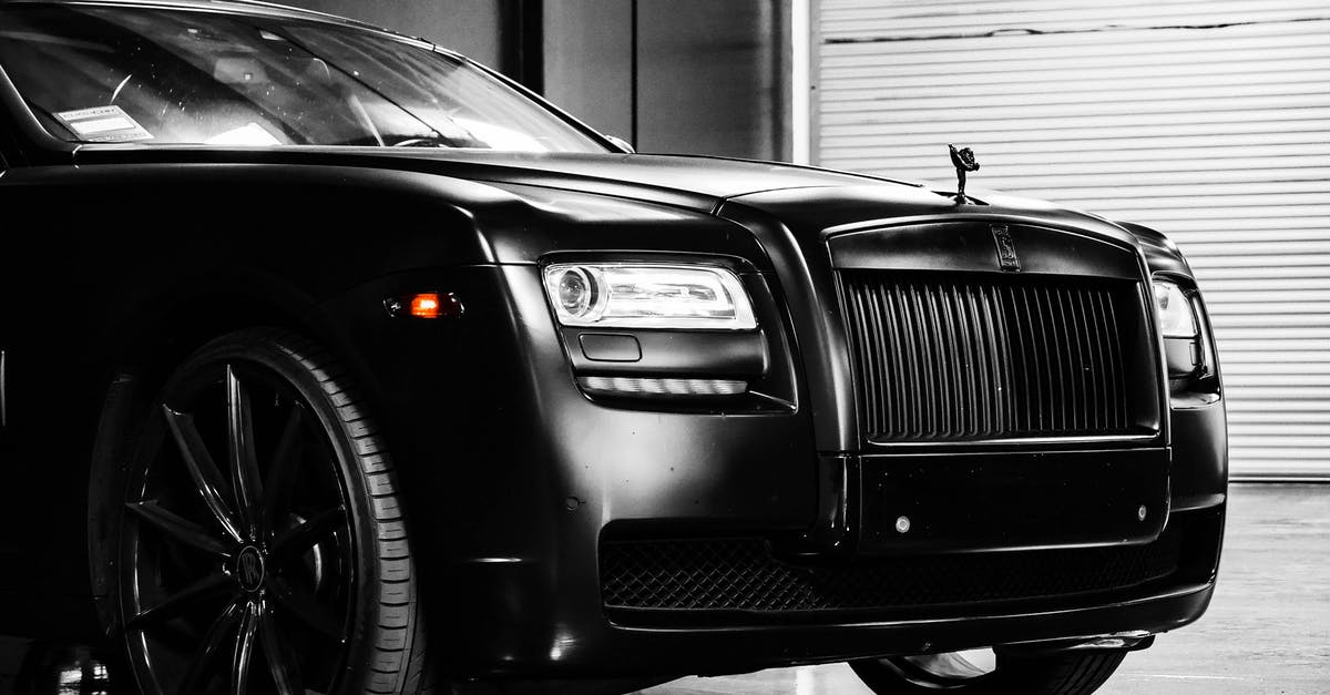 What u.s. car insurance is there for my British Land Rover with British plates? - Hood of elegant luxury black car parked on marble floor in modern building garage