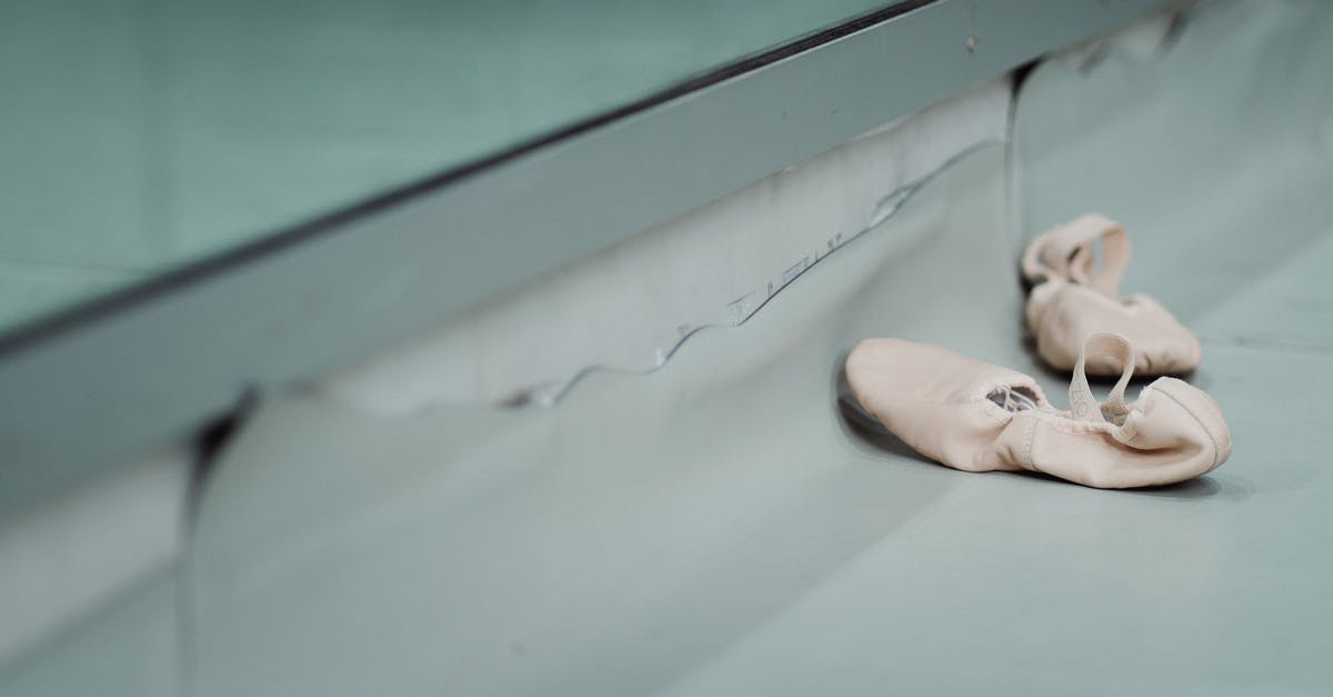 What US Visa do I need to perform in a theatre - High angle of pair of white pointe for dancing ballet placed on floor in dance studio What US Visa do I need to perform in a theatre - High angle of pair of white pointe for dancing ballet placed on floor in dance studio