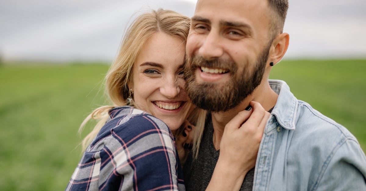 What would happen if told border patrol that my boyfriend was unemployed? - Man in Blue Denim Button Up Shirt Beside Woman in Purple and White Plaid Shirt
