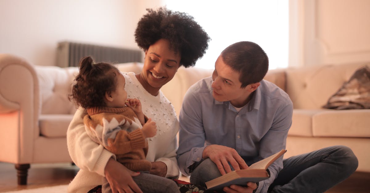 When a mother travels with baby (2 years) without father, what documents she needs to have for baby? - Photo of Man and Woman Having Fun With Their Child