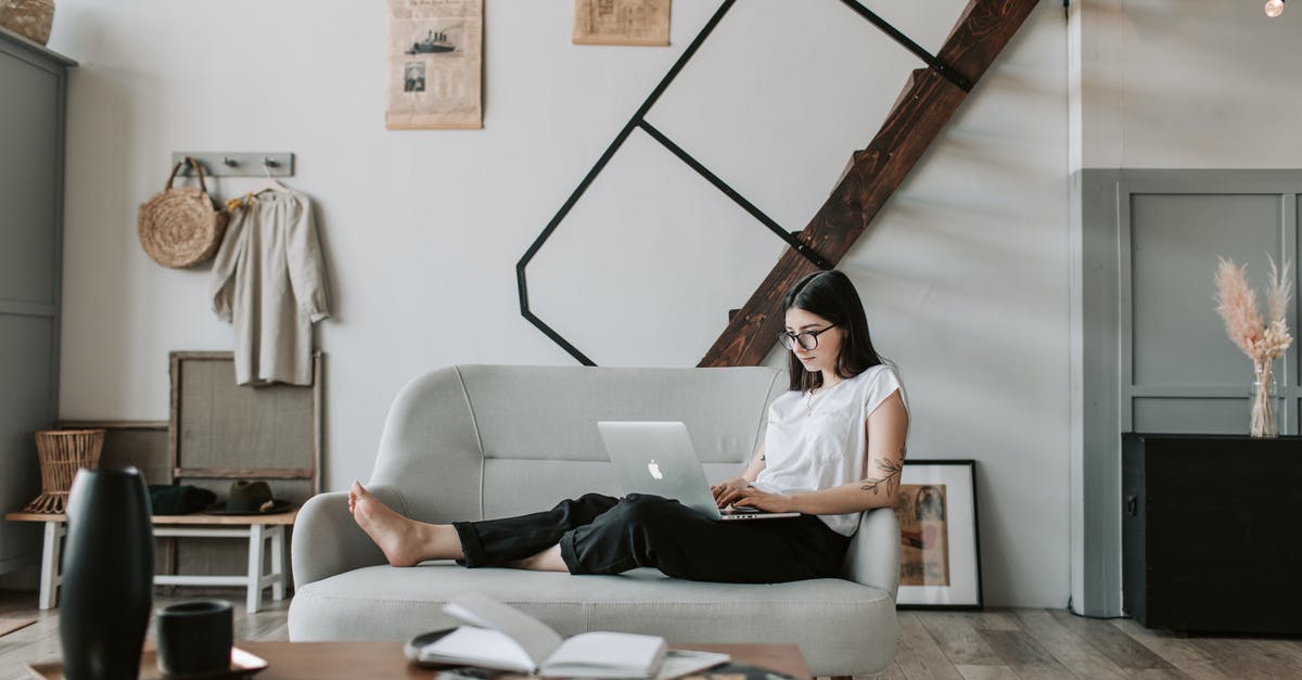 When booking flights/holidays through sites like Expedia, what does the email say? - Positive female with tattooed arms wearing casual clothes and eyeglasses reading netbook while sitting barefoot on comfortable sofa behind table with books and magazines in modern apartment with minimalist interior in eco style during free time When booking flights/holidays through sites like Expedia, what does the email say? - Positive female with tattooed arms wearing casual clothes and eyeglasses reading netbook while sitting barefoot on comfortable sofa behind table with books and magazines in modern apartment with minimalist interior in eco style during free time