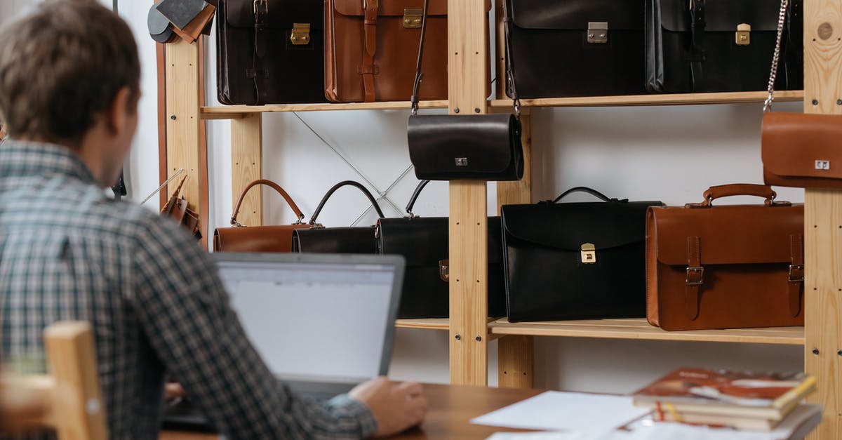 When Cabin Luggage weight limit is mentioned as 7kg, does it also include Laptop bag weight? - Person Using Macbook Pro on Brown Wooden Table When Cabin Luggage weight limit is mentioned as 7kg, does it also include Laptop bag weight? - Person Using Macbook Pro on Brown Wooden Table