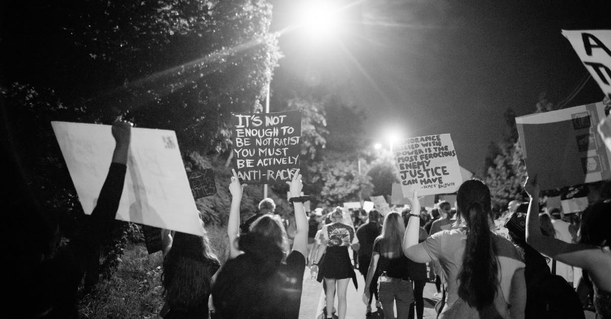 When do pedestrians have right of way in Australia? - Back view of black and white crowd of unrecognizable protesting people walking on street with banners during anti racism demonstration When do pedestrians have right of way in Australia? - Back view of black and white crowd of unrecognizable protesting people walking on street with banners during anti racism demonstration