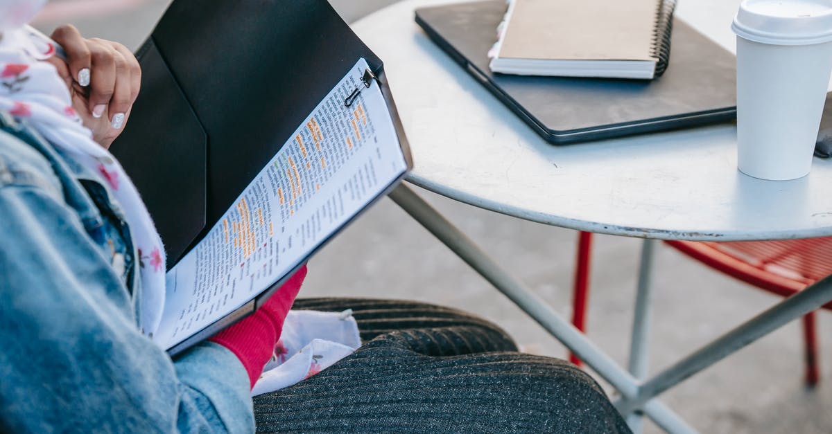 When flying AirAsia, do I need to get my documents checked before going to the gate? - Student sitting at table and reading report in folder in daytime When flying AirAsia, do I need to get my documents checked before going to the gate? - Student sitting at table and reading report in folder in daytime
