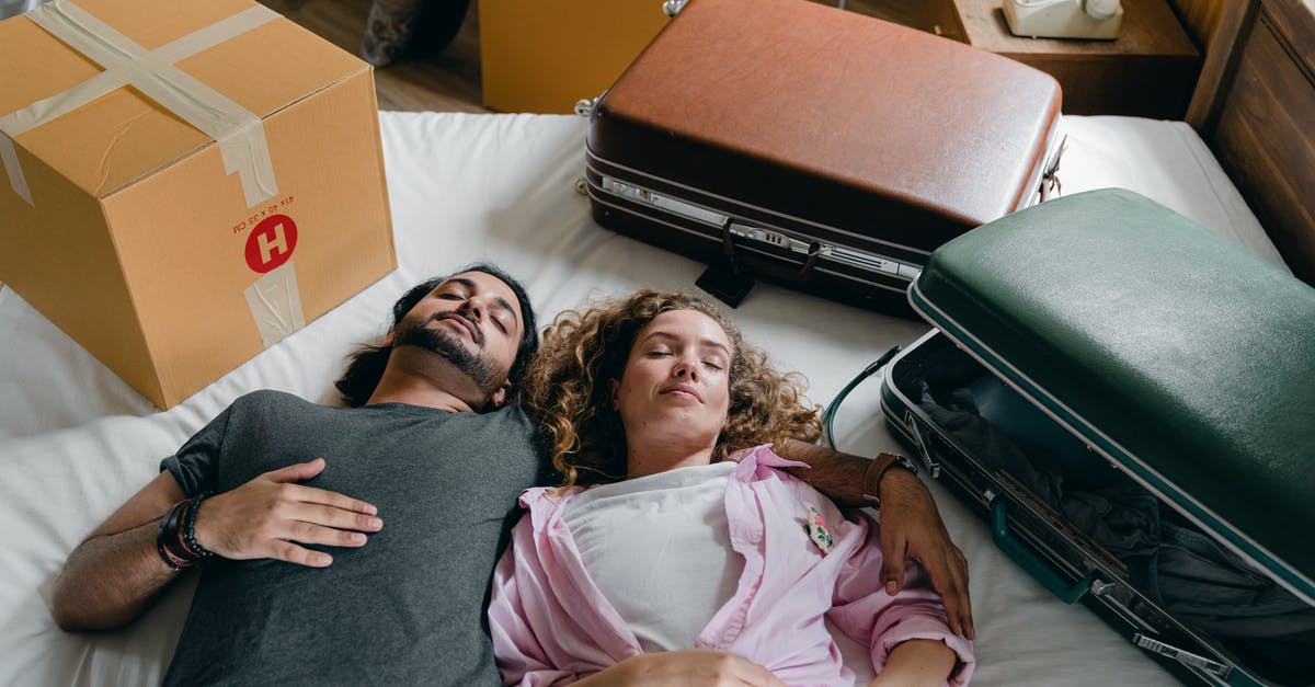 When I tavel from Papua new Guinea to US, do I need both a Visa and a Passport? [closed] - Sleeping diverse couple lying on bed during relocation in new house