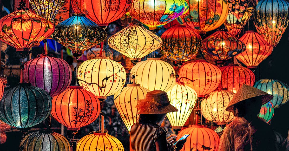 When is the peak travel time during Chinese New Year? - Two Person Standing Near Assorted-color Paper Lanterns When is the peak travel time during Chinese New Year? - Two Person Standing Near Assorted-color Paper Lanterns