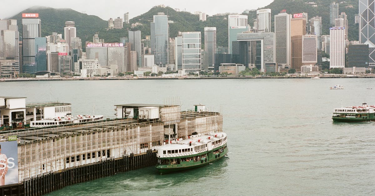 When should we arrive at the terminal for the ferry from Hong Kong to Macau? - A Ferry at the  Hong Kong Ocean Terminal in Victoria Harbour, Hong Kong