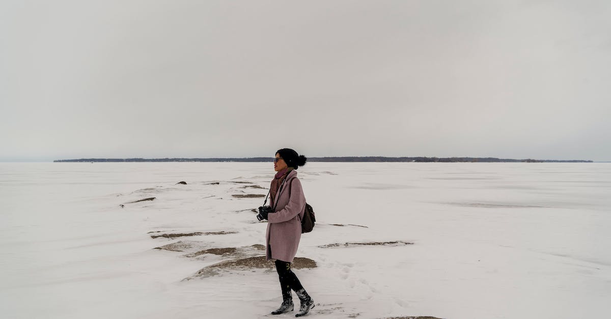 When travel insurance covers natural disasters - Woman in Pink Jacket Standing on Snow Covered Ground When travel insurance covers natural disasters - Woman in Pink Jacket Standing on Snow Covered Ground