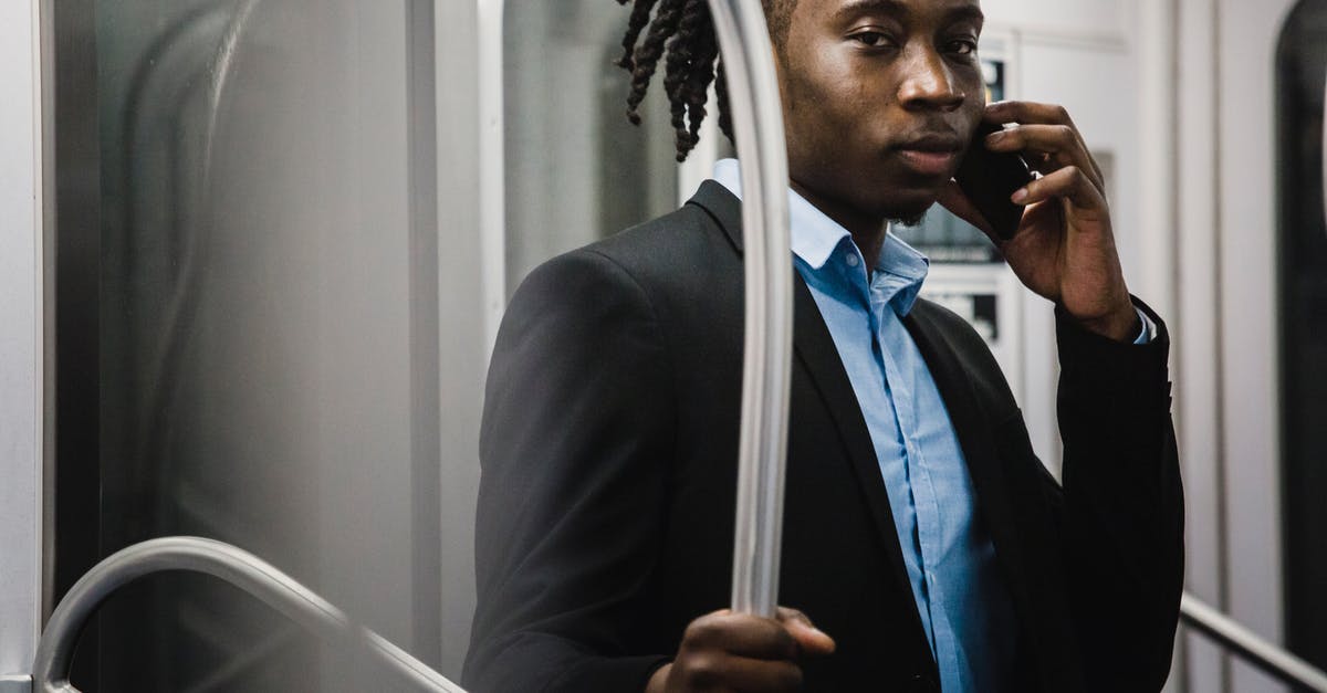 When using rail passes in Germany, can I use it in "urban trains" as well? (U-bahn, S-bahn) - Young pensive black office worker making phone call while commuting home by underground train