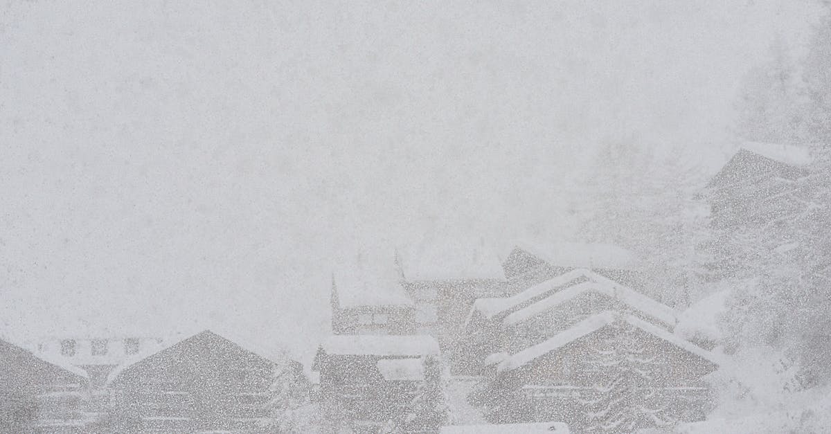 When visiting northern India in September, where to begin weather-wise? - Severe scenery of remote rural village houses covered with thick layer of snow during intense snowstorm on cold winter day