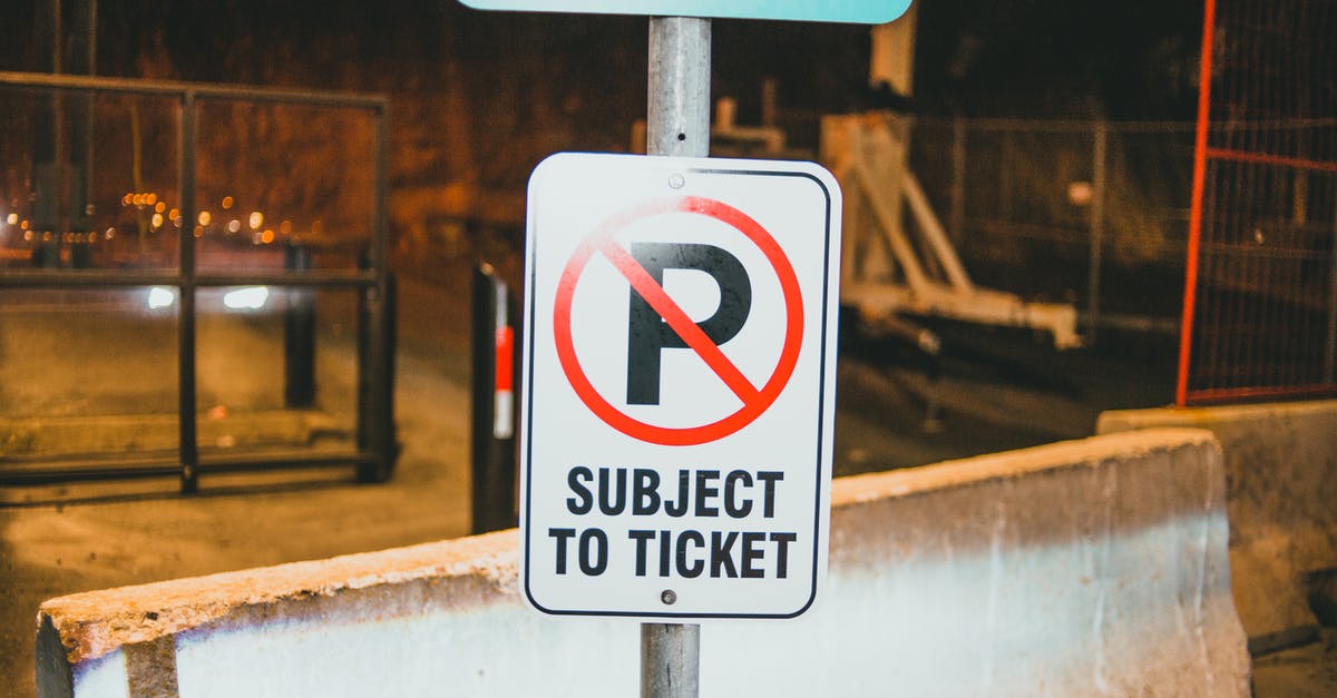 When will I encounter UK border control - Prohibition parking road sign with Subject To Ticket inscription placed on street of city near concrete barrier in evening time When will I encounter UK border control - Prohibition parking road sign with Subject To Ticket inscription placed on street of city near concrete barrier in evening time