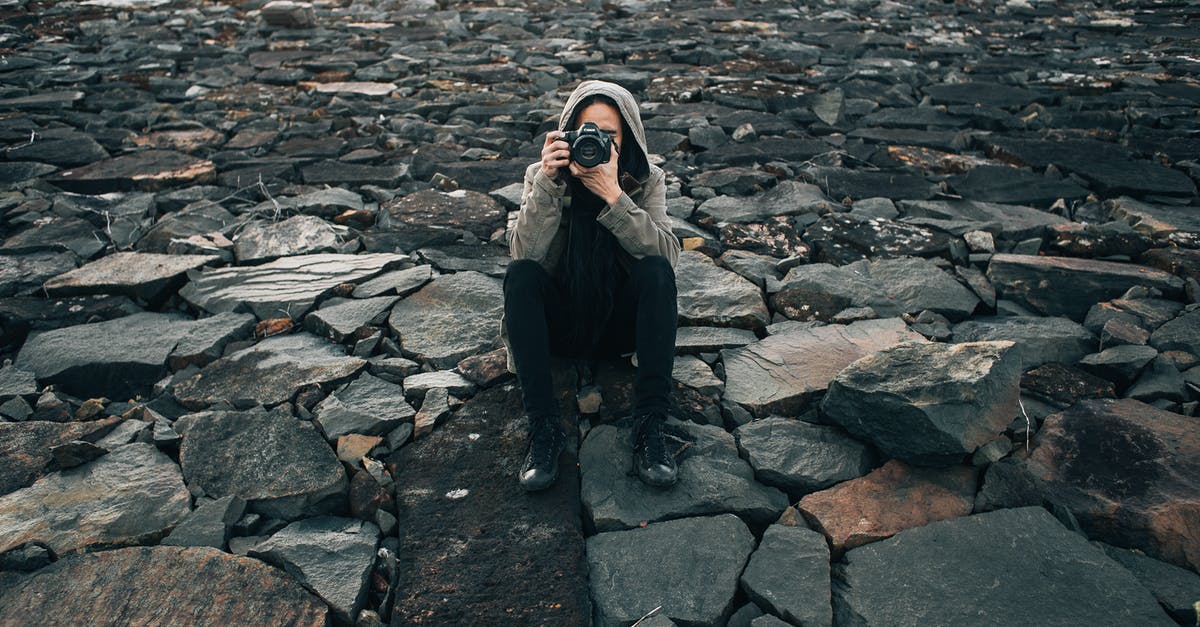 Where's this picture of a glacial moraine in autumn taken? - Concentrated photographer taking picture on stones Where's this picture of a glacial moraine in autumn taken? - Concentrated photographer taking picture on stones