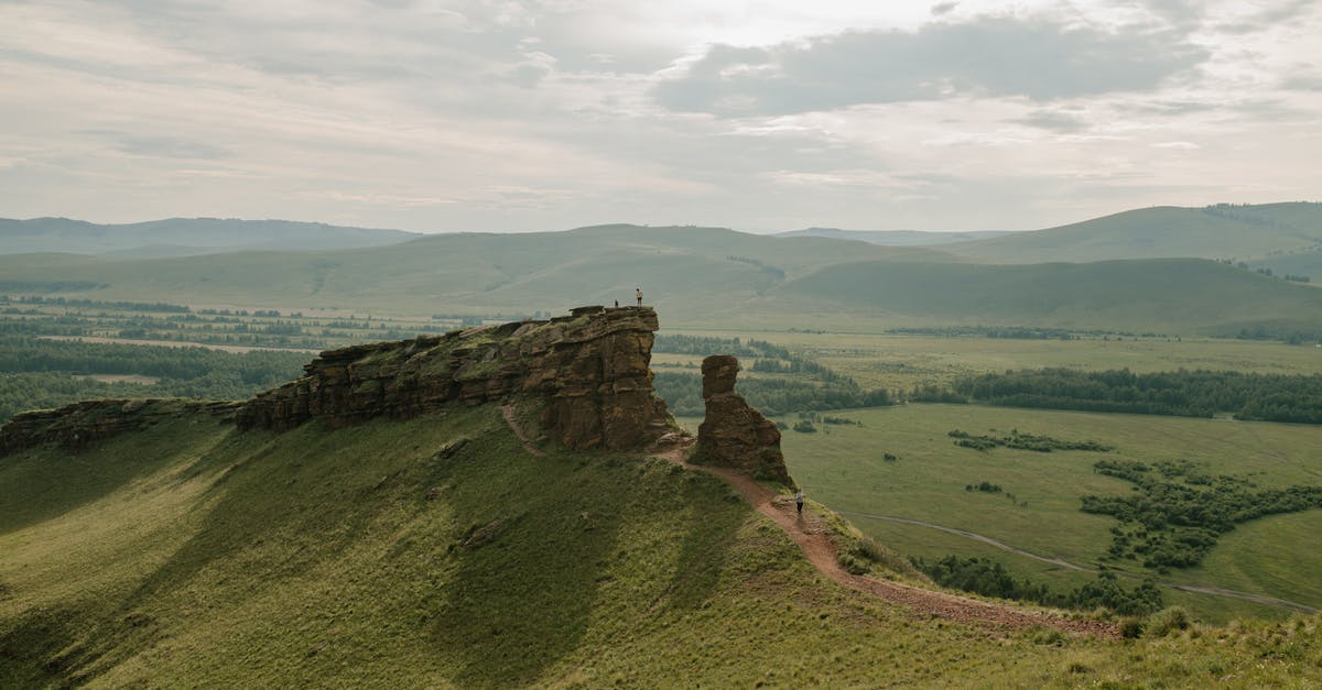 Where's this verdant ridge? - Peaceful verdant fresh fields and hills with green bushes and rocky terrain in summer Where's this verdant ridge? - Peaceful verdant fresh fields and hills with green bushes and rocky terrain in summer