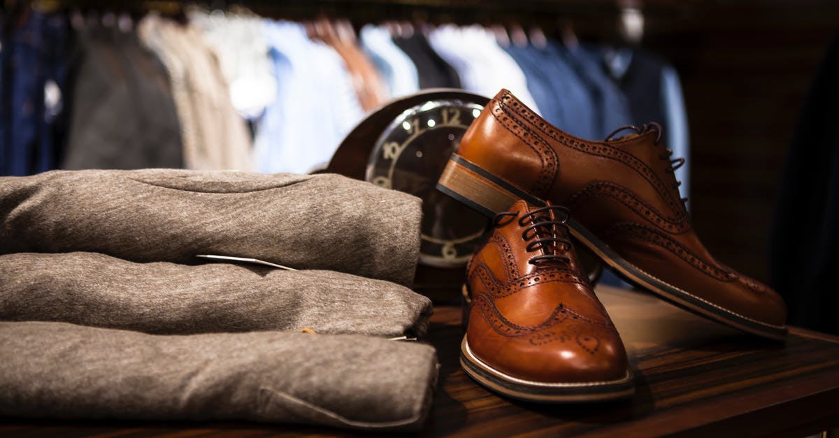 Where are the main clothes shopping areas in London? [closed] - Pair of Brown Leather Wingtip Shoes Beside Gray Apparel on Wooden Surface