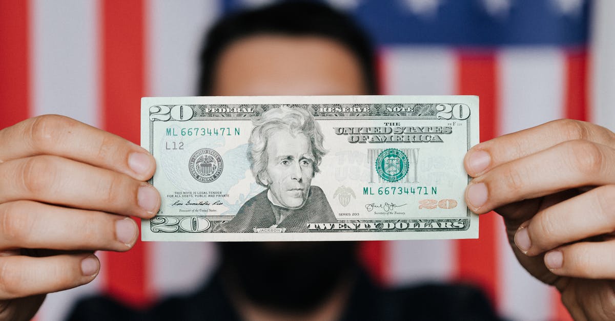 Where can a European buy a US prepaid credit card with a registration address in the US? [duplicate] - Unrecognizable man showing 20 American dollars